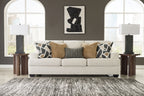 Beige upholstered sofa with patterned throw pillows, plus matching accent pillows