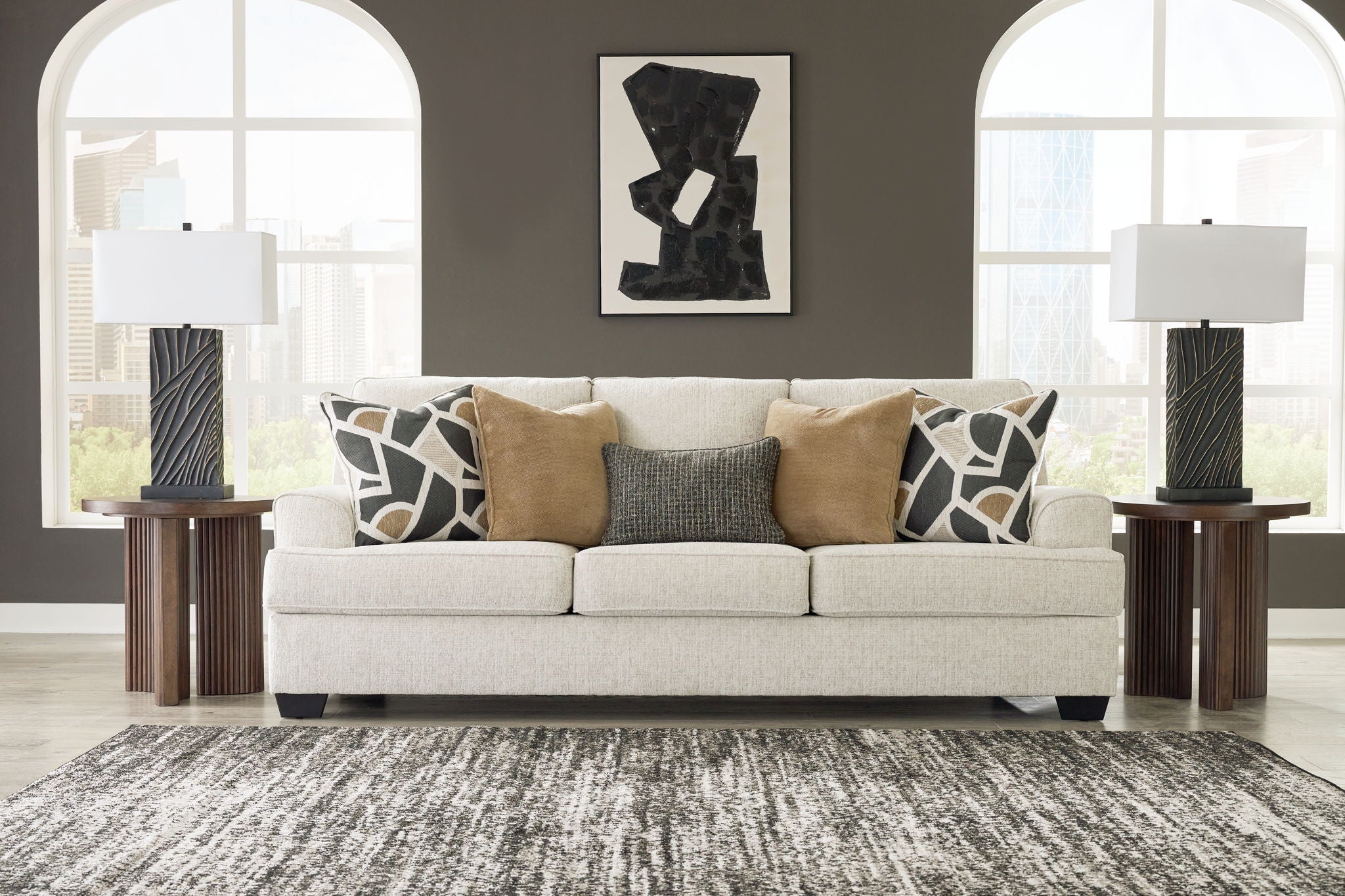 Beige upholstered sofa with patterned throw pillows, plus matching accent pillows