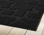 Washable rug, black, brick-pattern texture with bound edge
