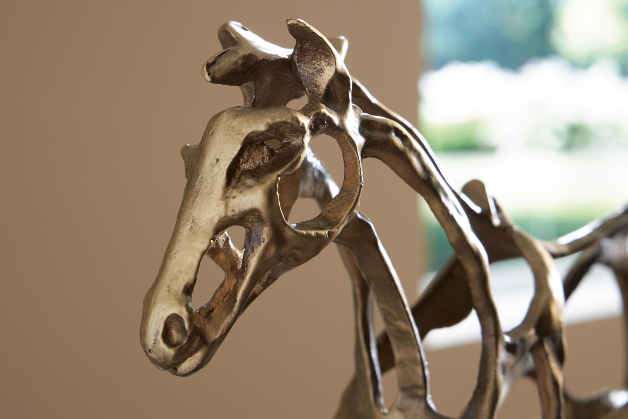 antique gold horse sculpture head and neck detail on dark base