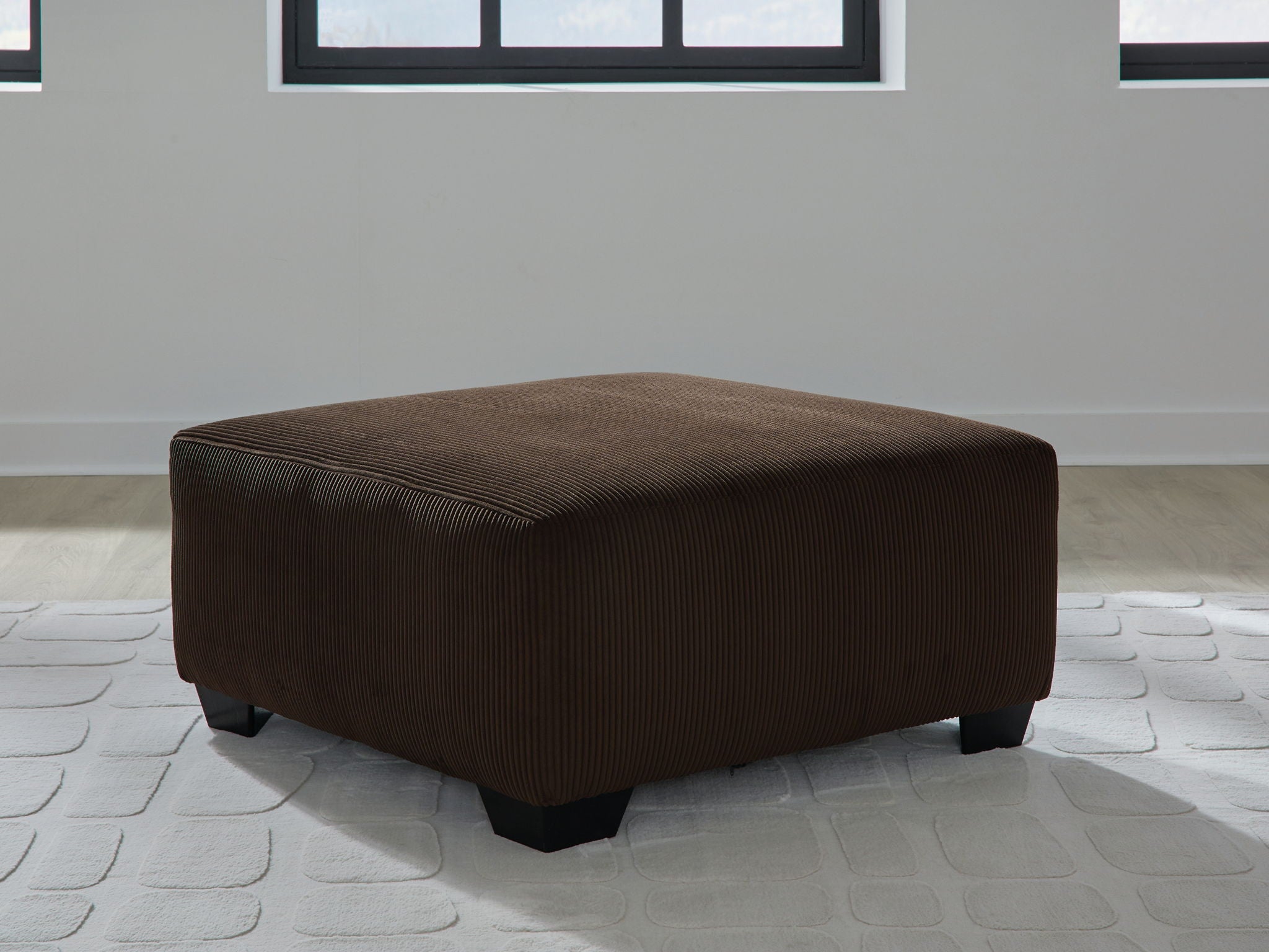 Oversized accent ottoman in chocolate-brown corduroy fabric, square top and base