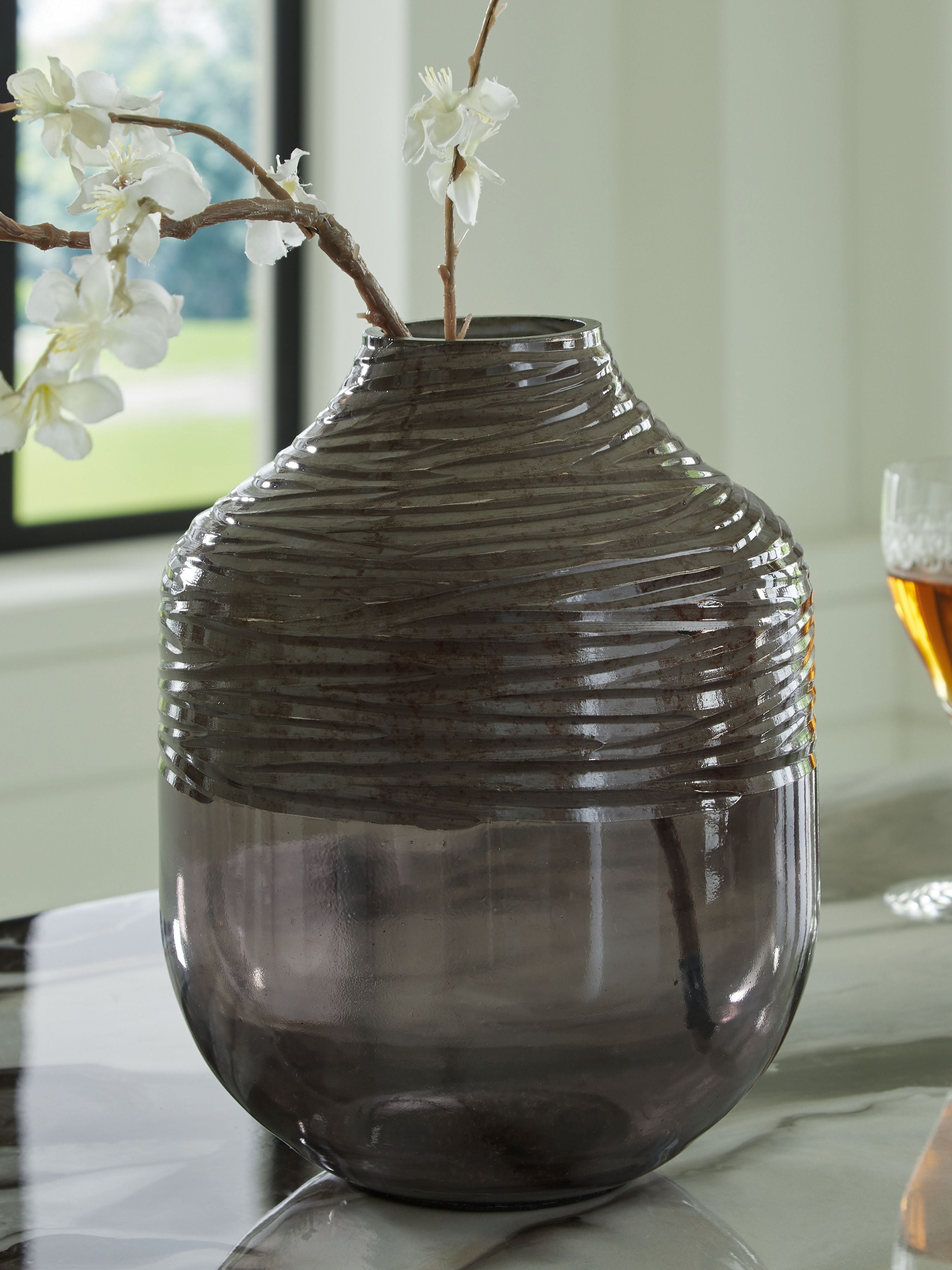 Harpwick dark gray ribbed glass vase with flowers and reflections