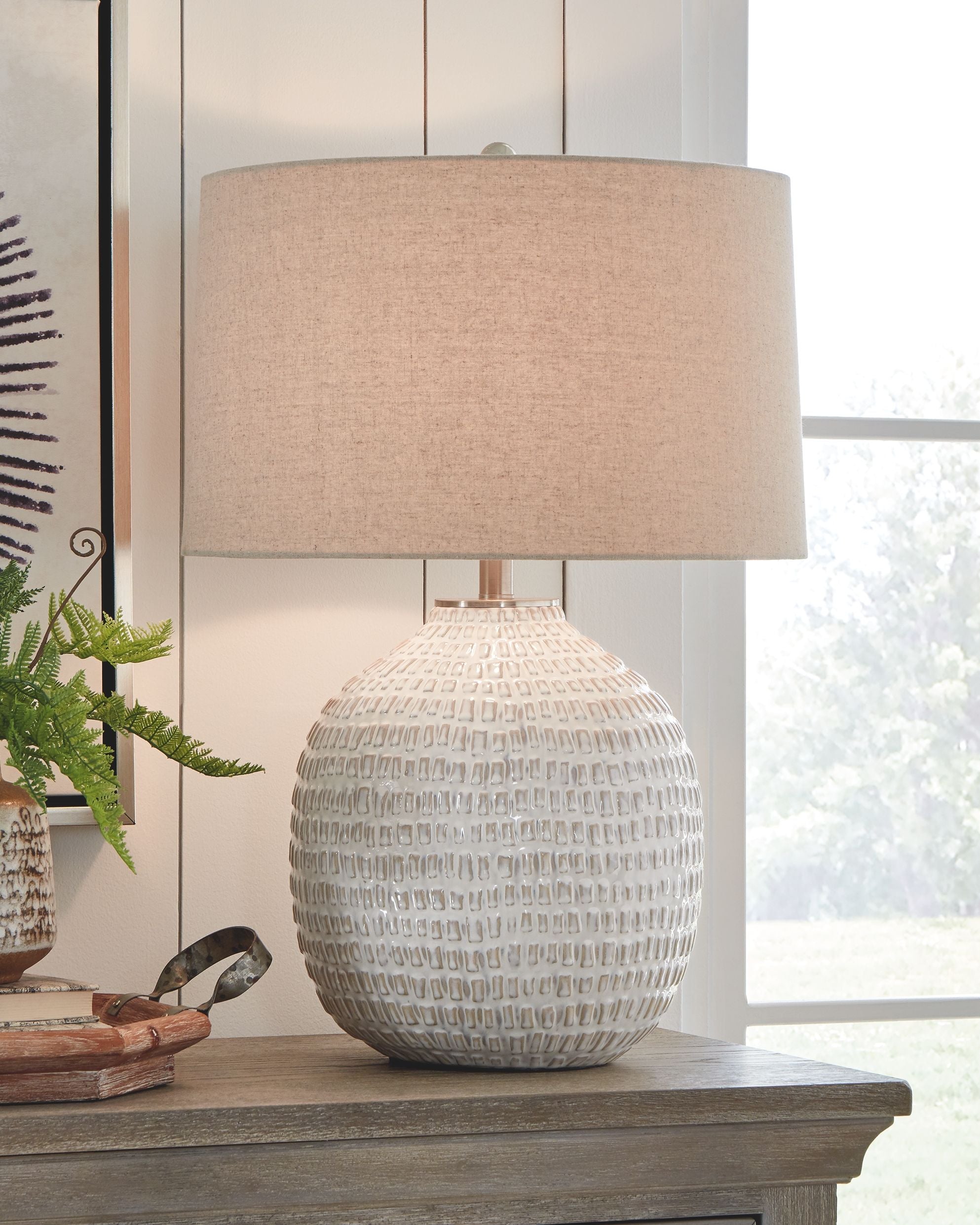 Beige ceramic table lamp with fabric drum shade and textured globe base