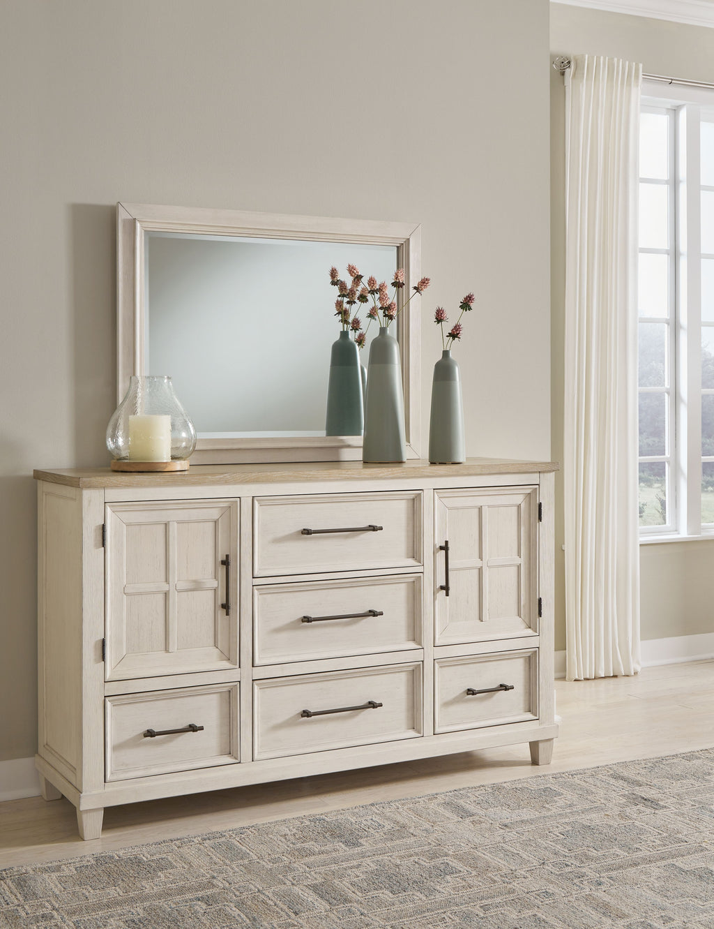 Antique white dresser with framed mirror and paneled cabinet doors with pulls