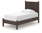 Dark brown panel platform bed frame with white mattress and single pillow