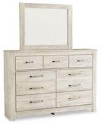 Light beige dresser with attached mirror; nine drawers with silver bar hardware