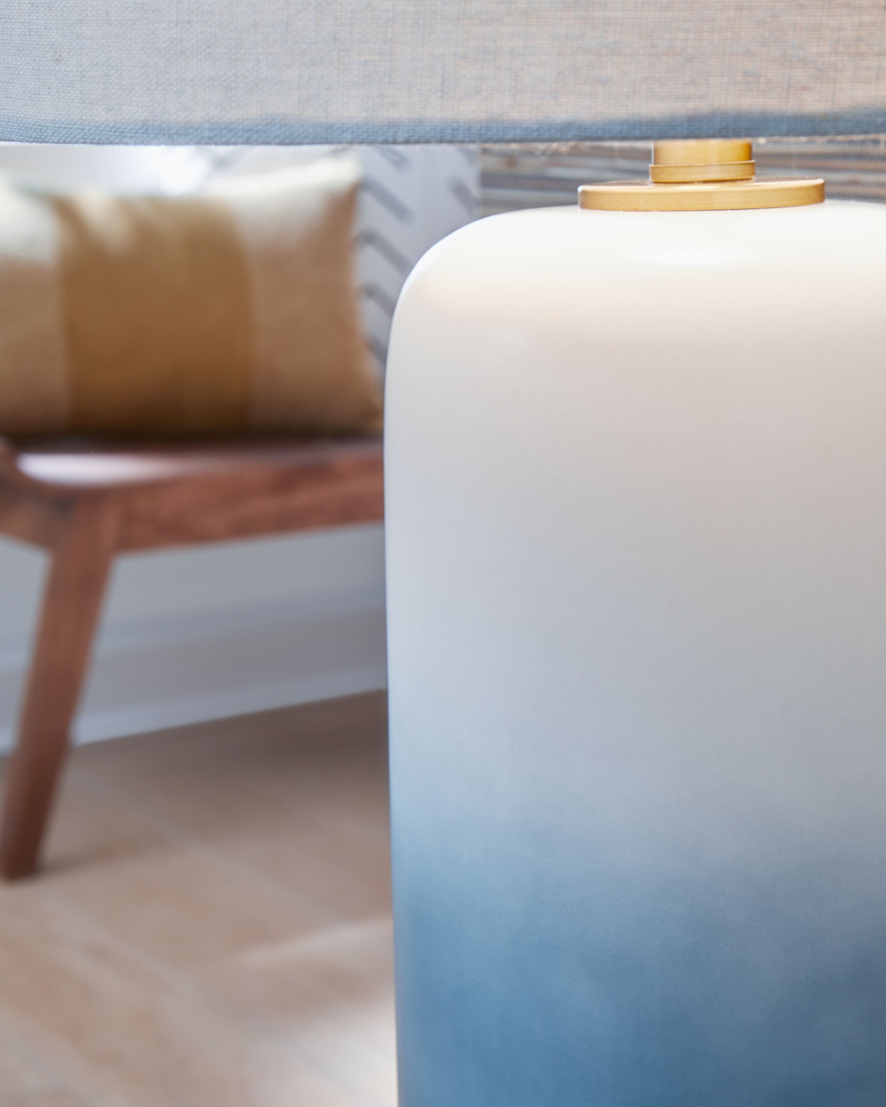 Ceramic table lamp base with gold stem and white fabric shade top