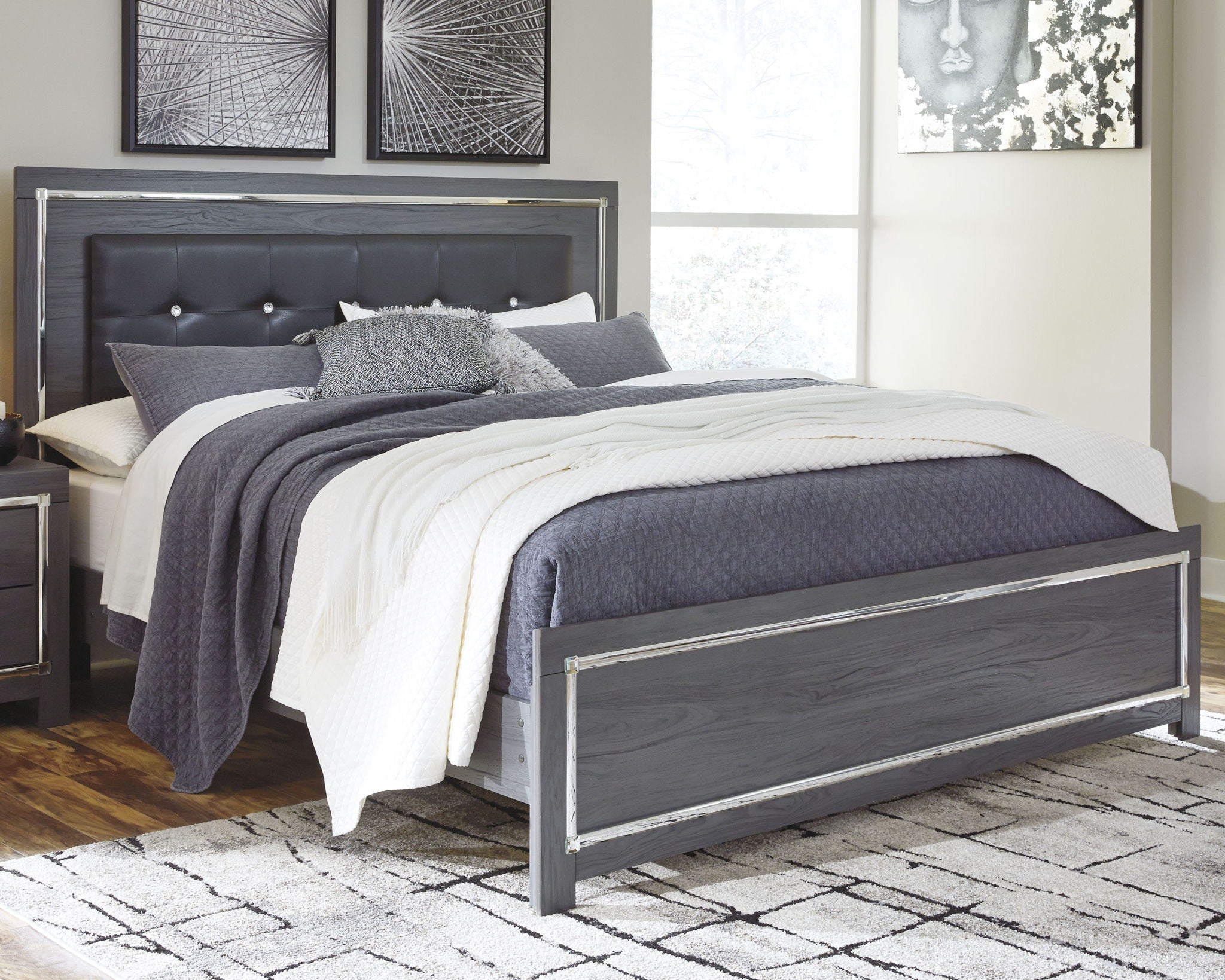 Gray panel bed with dark headboard and storage drawers, dressed with gray-and-white bedding
