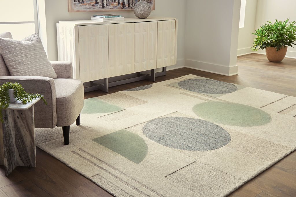 Ivory area rug with large abstract ovals and geometric lines in gray and sage