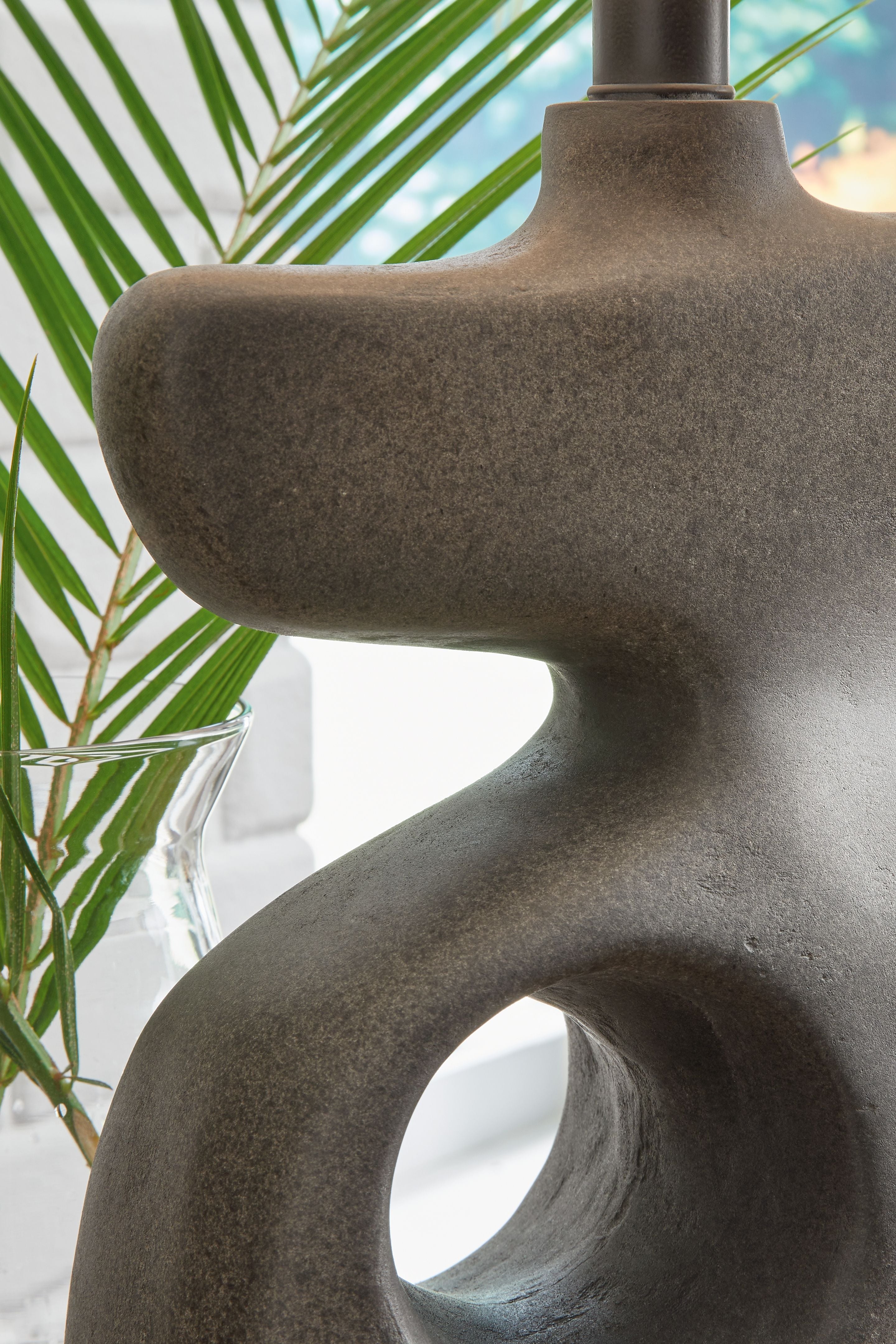 Danacy paper table lamp sculpted dark gray base with oval cutouts and textured beige shade