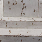 Close-up of distressed white lamp base with brown speckled paint marks