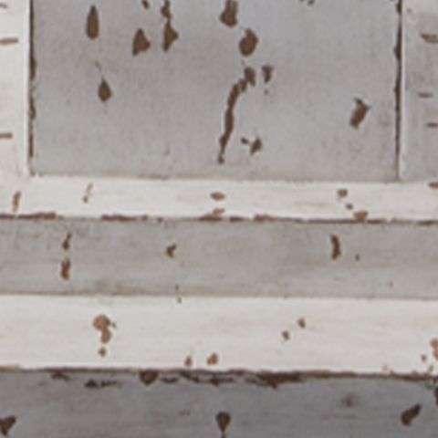 Close-up of distressed white lamp base with brown speckled paint marks