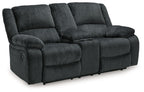 Dark gray reclining loveseat with padded arms and split back cushions