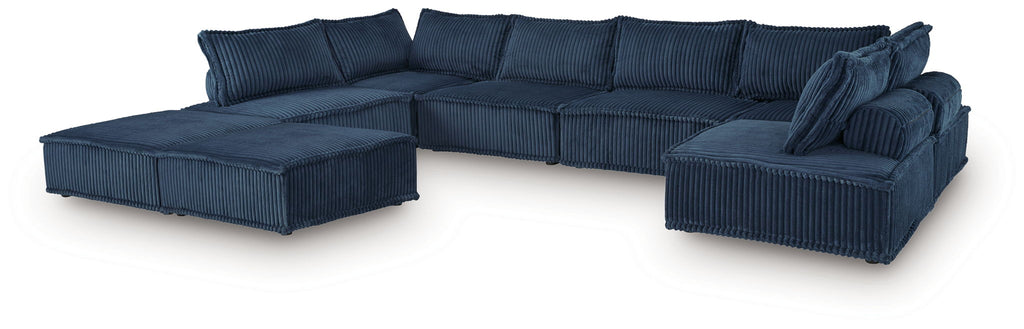 Navy modular sectional sofa with chaise and tufted back cushions, sectional layout