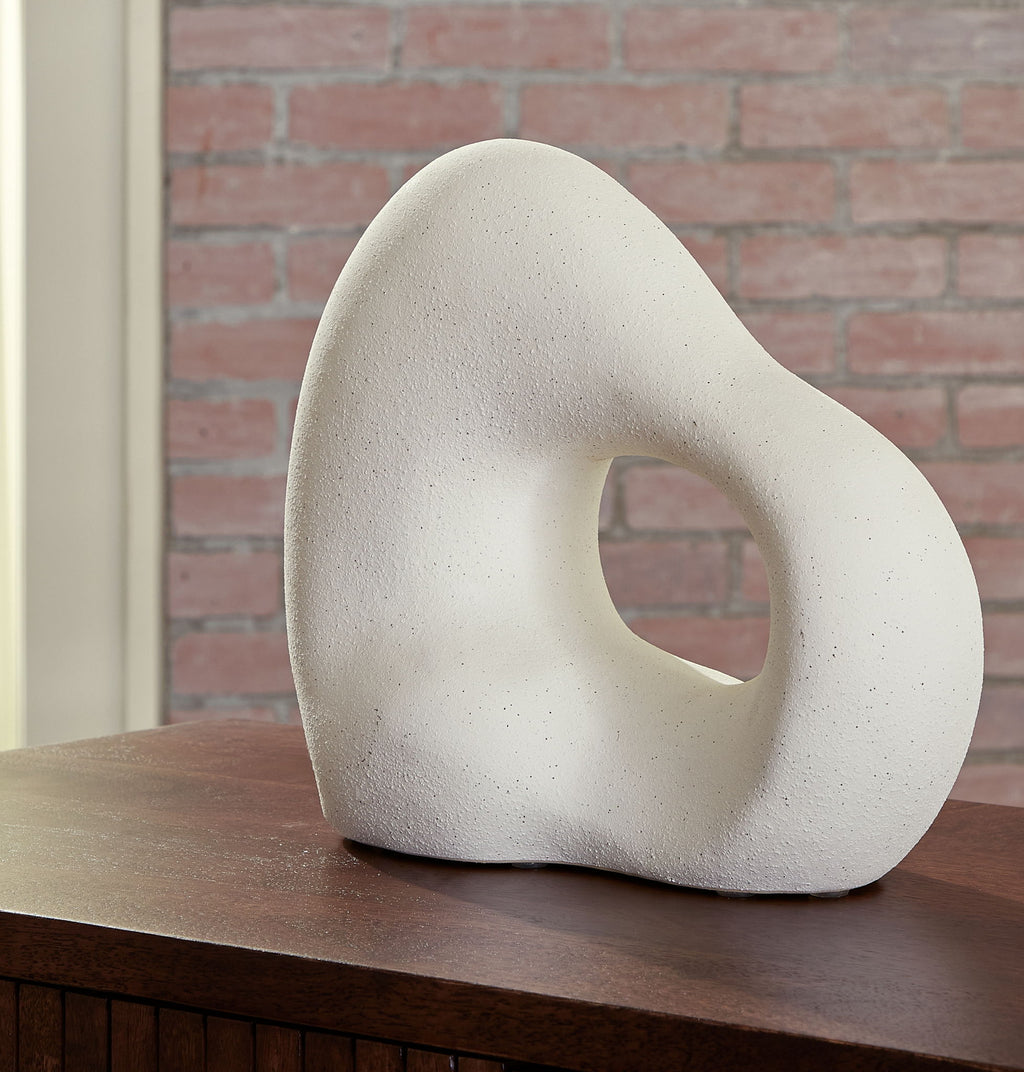 Off-white abstract sculpture with standing teardrop shape and oval hole