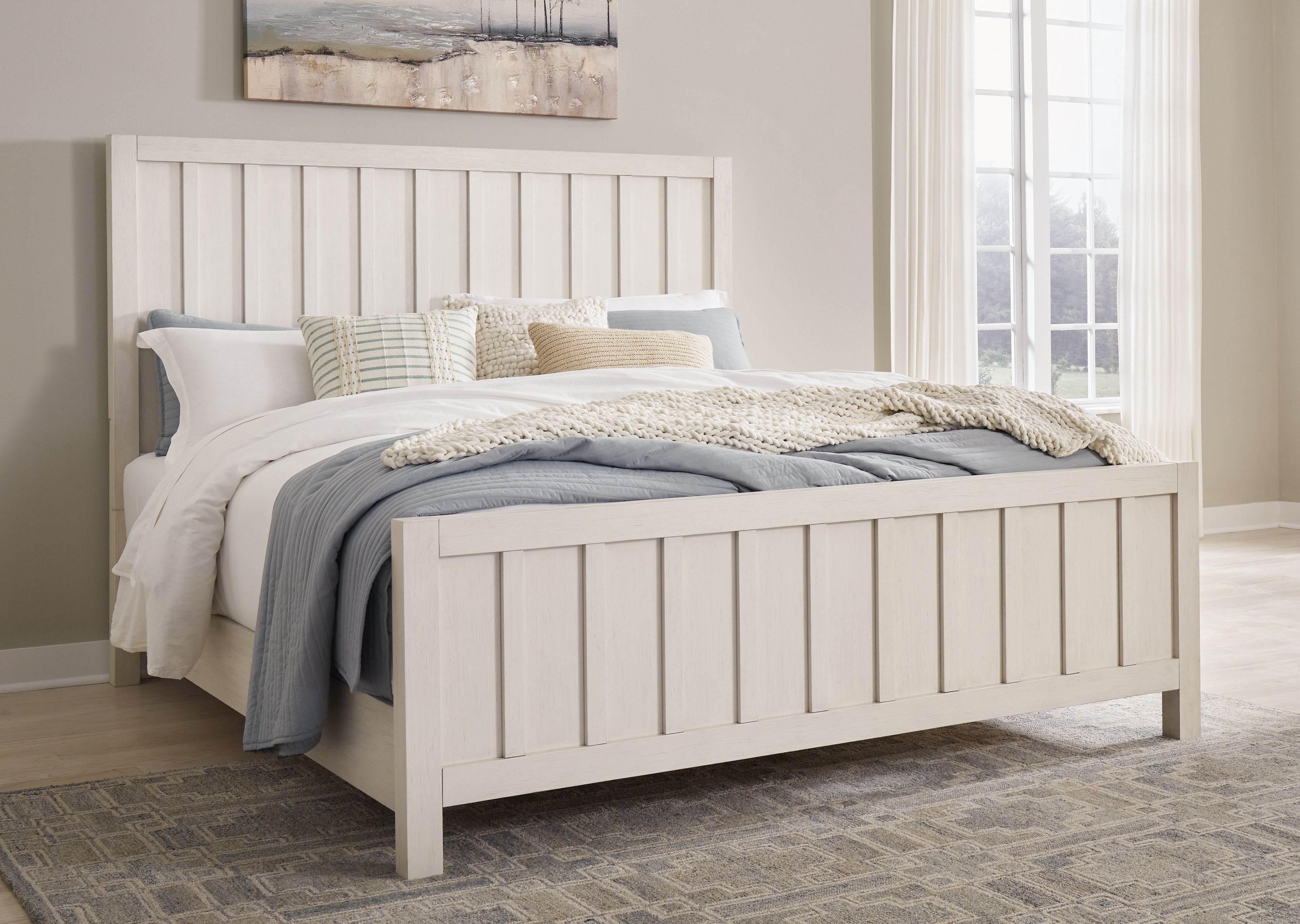 White panel bed with tall slat headboard, mattress, and pillows in a bedroom setting