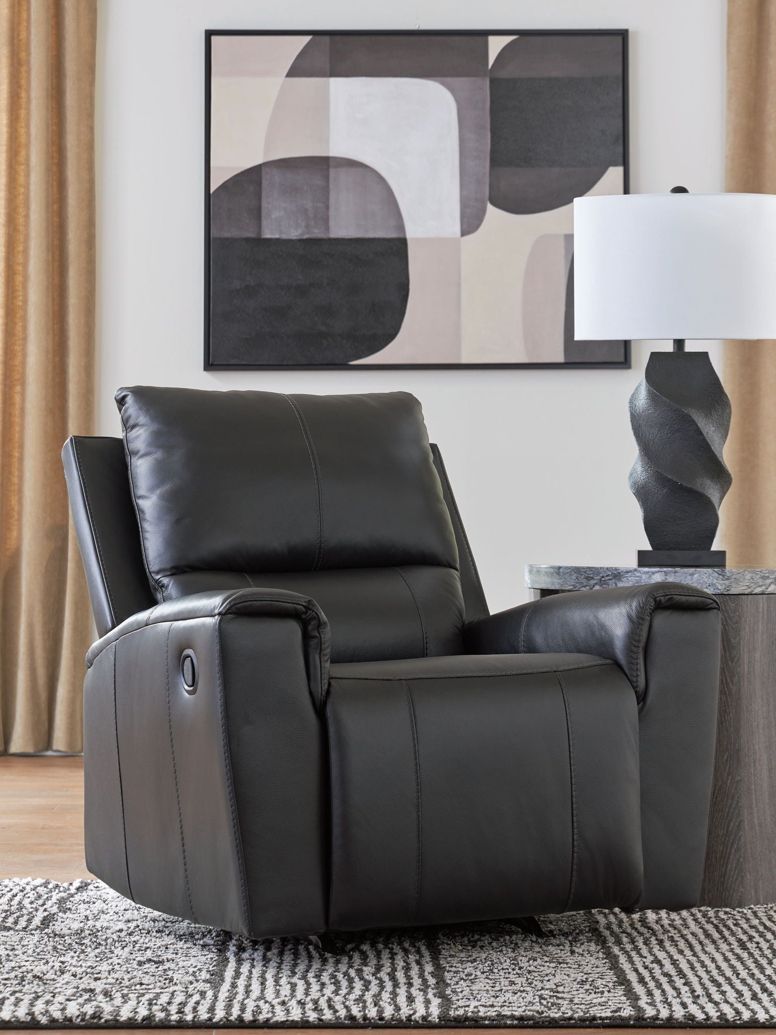 Black leather-look rocker recliner chair with padded arms and recline ottoman