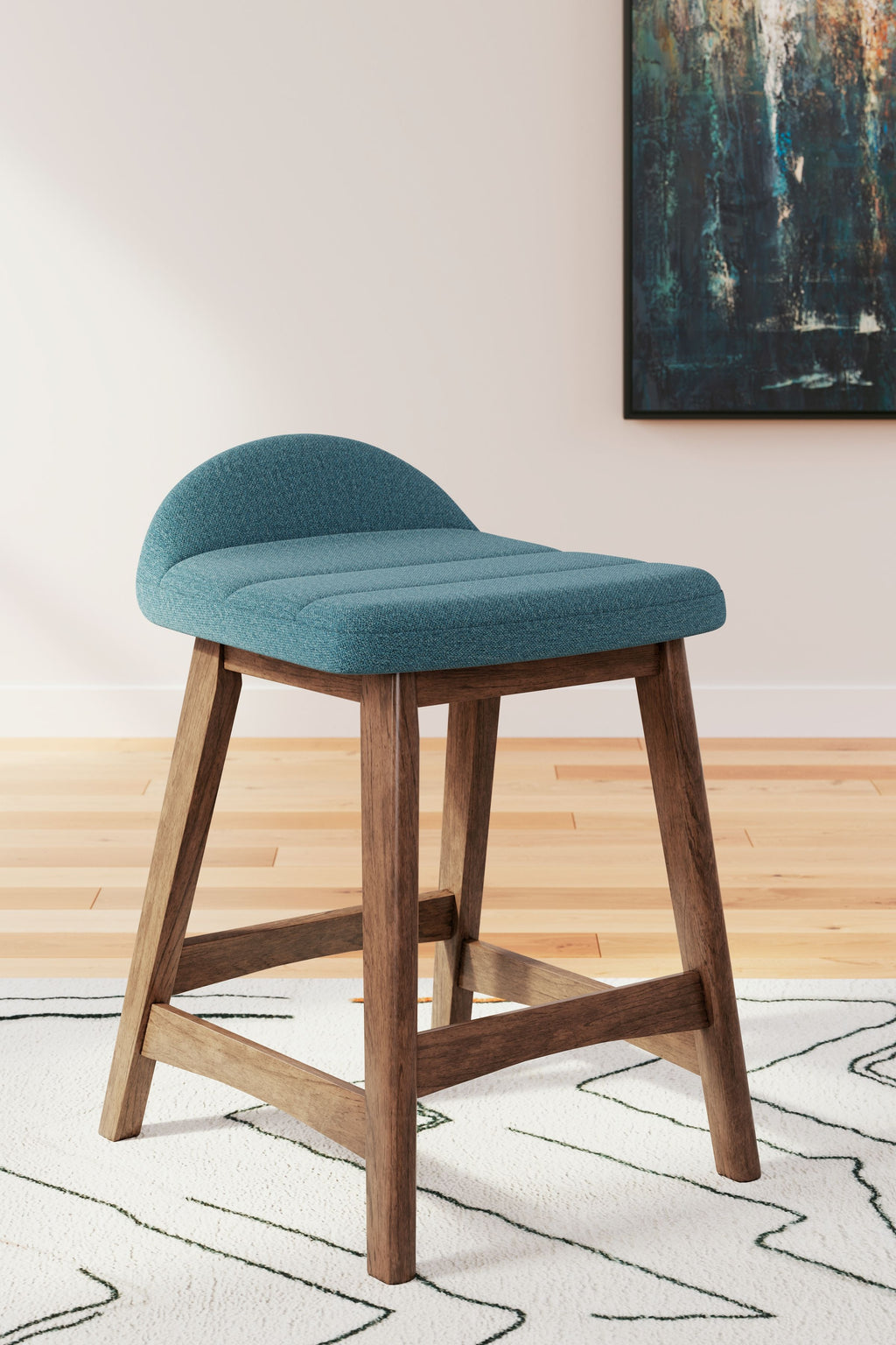 Upholstered barstool with teal fabric seat and back, light wood legs