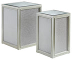 Silver nesting end tables set with textured panel fronts and glass tops, angled view