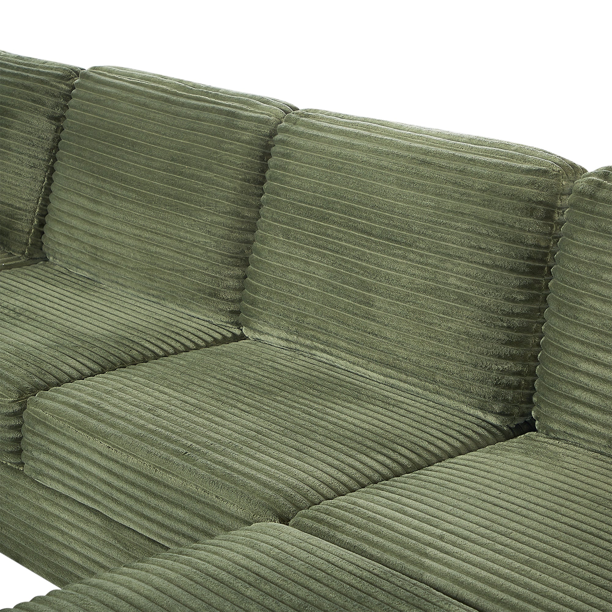 Green corduroy sectional sofa cushion close-up with stitched seams