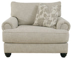 Light gray linen-style armchair with rounded arms and patterned accent throw pillow