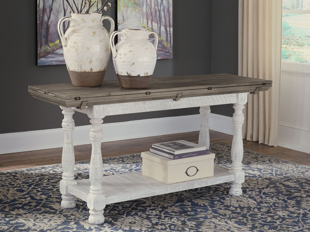 Gray flip-top sofa table with white turned legs and lower shelf, front-left angle