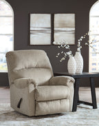 Taupe rocker recliner chair with padded headrest and armrests in a living room