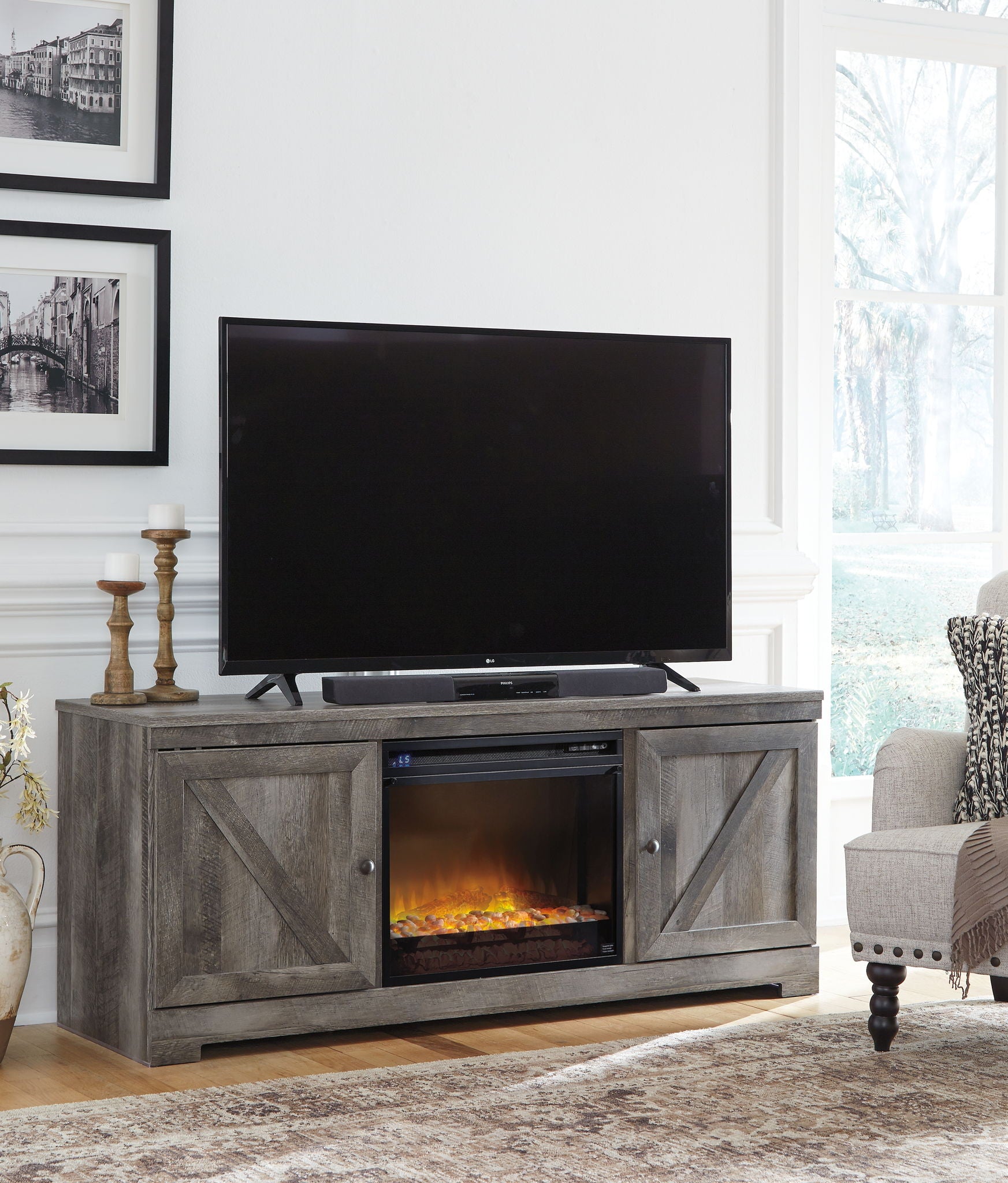 Gray fireplace TV console with glass-front insert and two framed cabinet doors