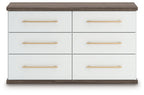 Six-drawer dresser with white finish, warm wood top and sides, and gold bar pulls.