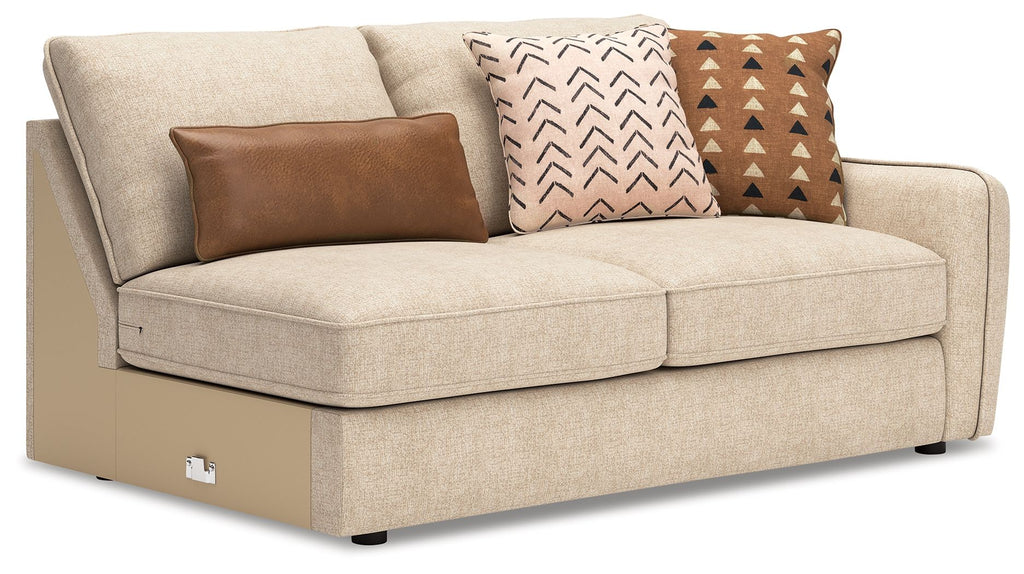 Seyler RAF sand sofa with two seat cushions and three patterned throw pillows.