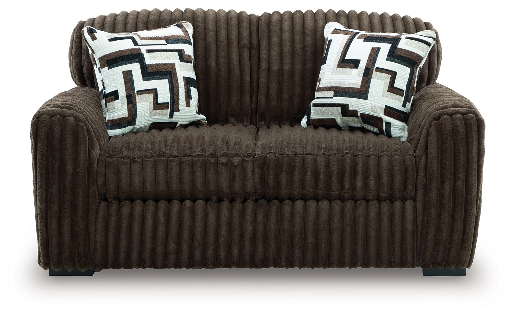 Dark brown loveseat with two geometric throw pillows and tufted front cushion