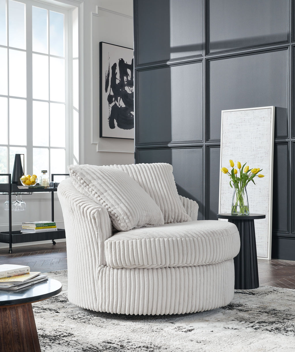 Swivel chair with ribbed light upholstery, two back cushions, and rounded armrests
