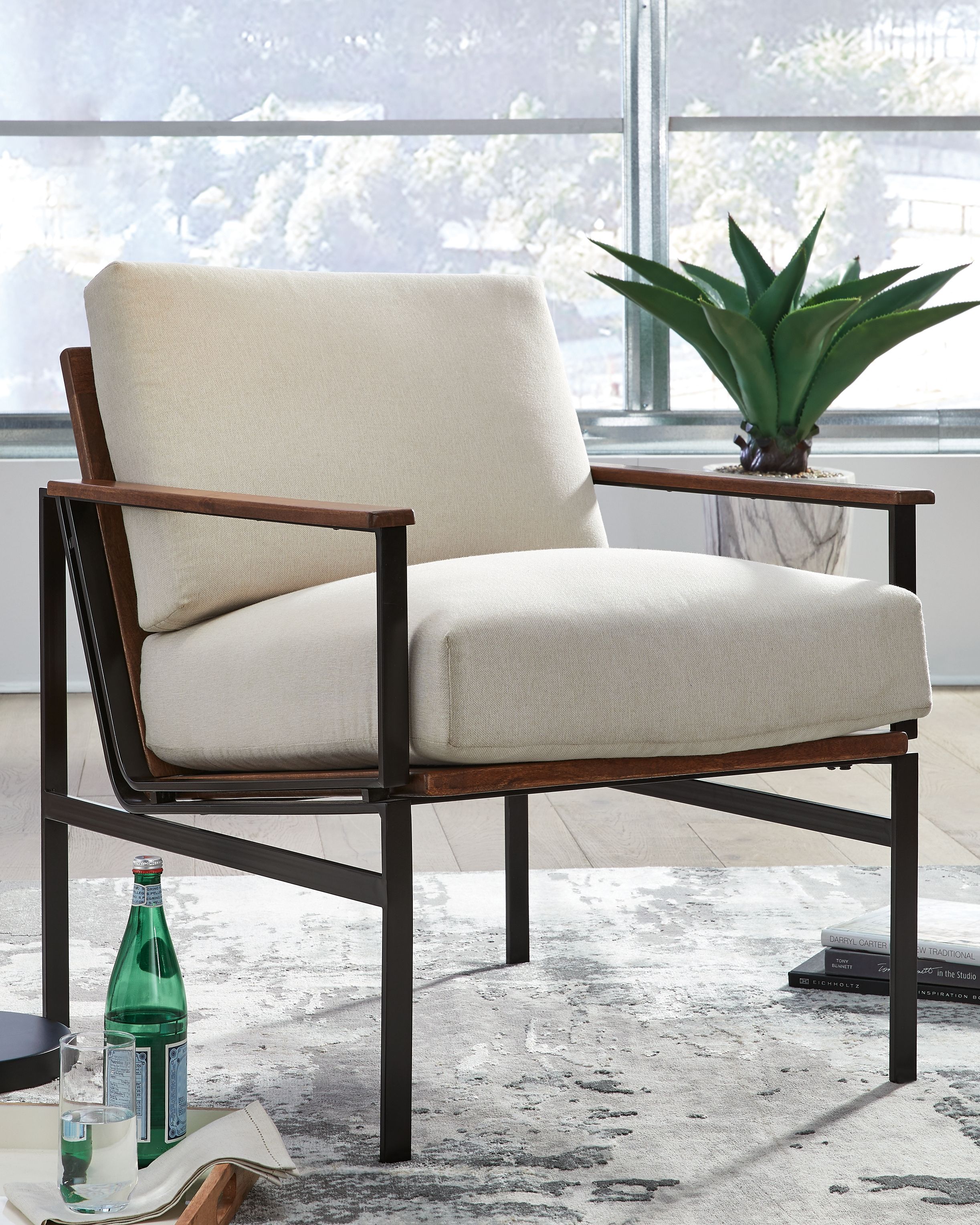 Tilden accent chair with ivory upholstery and brown wood armrests, black metal frame
