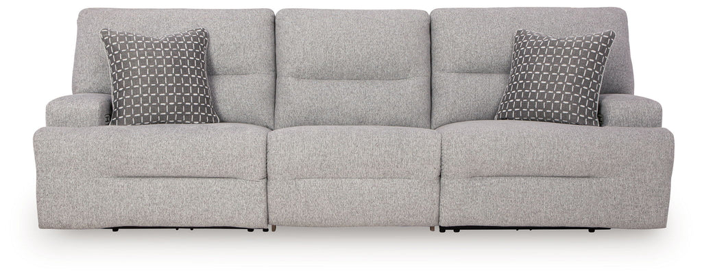 Pewter sectional sofa with three seat sections and two patterned accent pillows