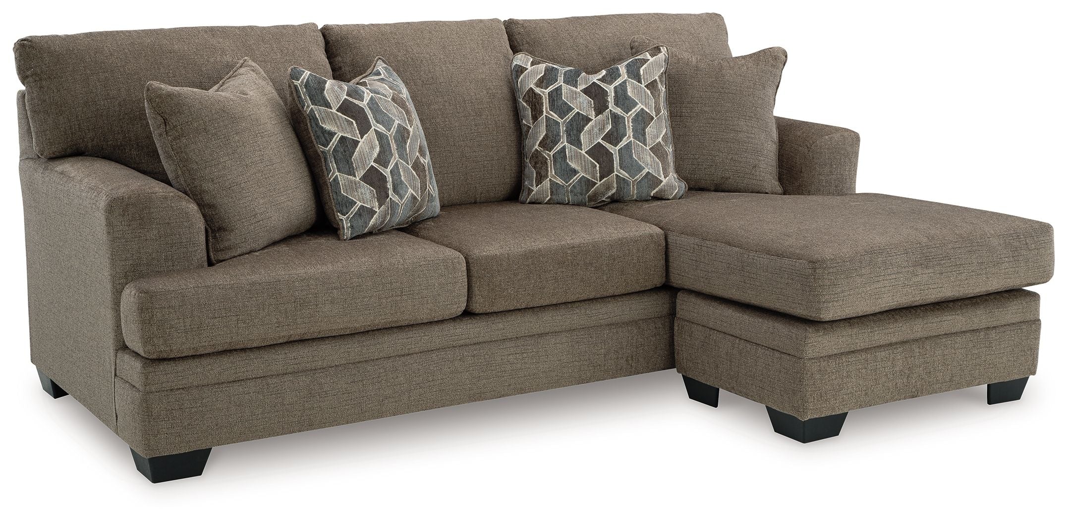 Taupe sofa chaise with two geometric patterned throw pillows and extended chaise section