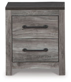Two-drawer night stand close-up with gray woodgrain drawers and black pull handles.