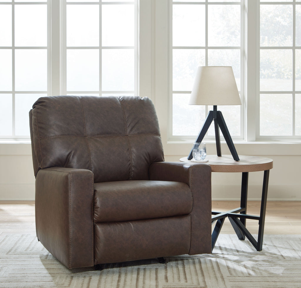 Brown rocker recliner with padded arms, tufted back, and smooth cushioned seat