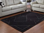 Black geometric area rug with white outlined rectangles and diamonds on hardwood