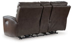 Dark brown power reclining loveseat with exposed footrest mechanism under seat