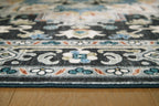 Washable area rug border close-up with black ground and light blue floral accents.