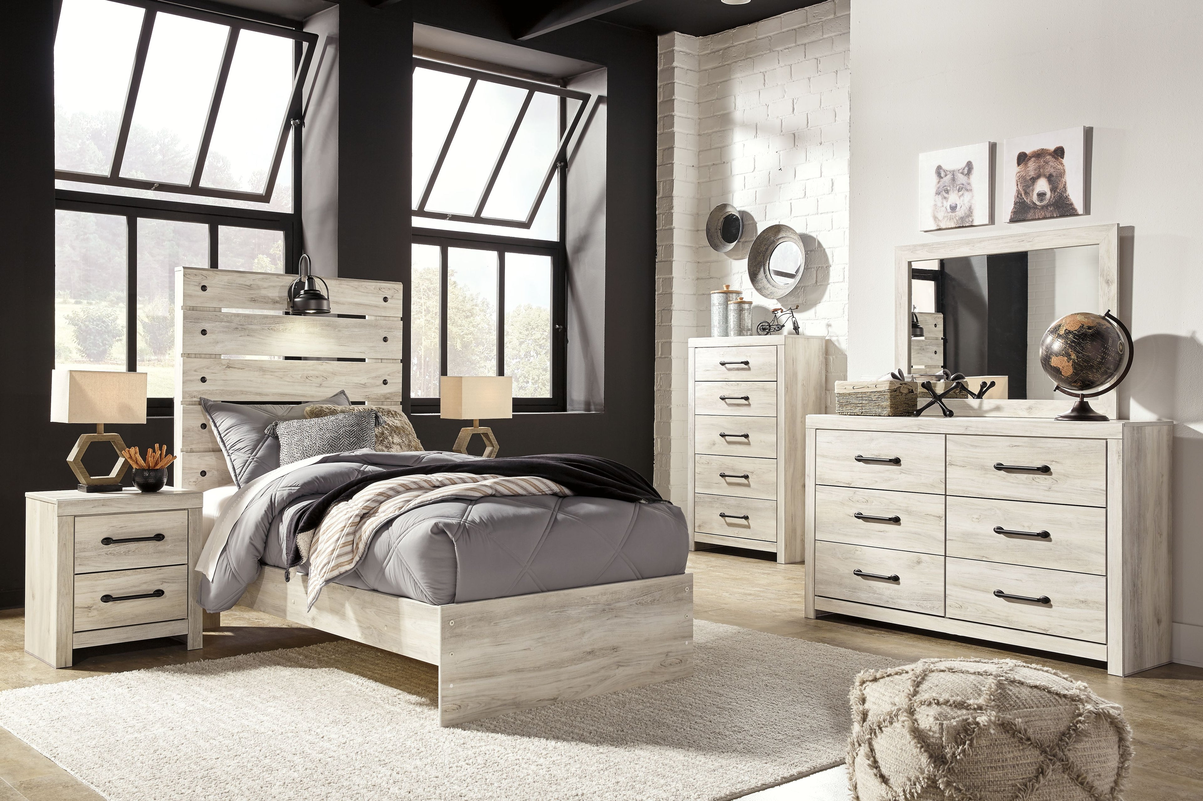 Youth bedroom set with light wood bed, two nightstands, and wide dresser with mirror