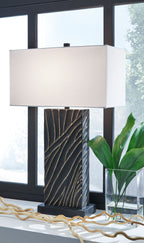 Black table lamp with white fabric shade and gold vein-like patterned poly body