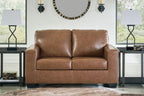 Light brown loveseat with two back cushions, padded arms, and dark legs
