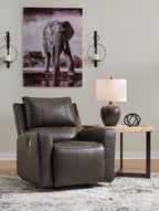 Dark brown power rocker recliner chair with padded headrest, seat, and armrests