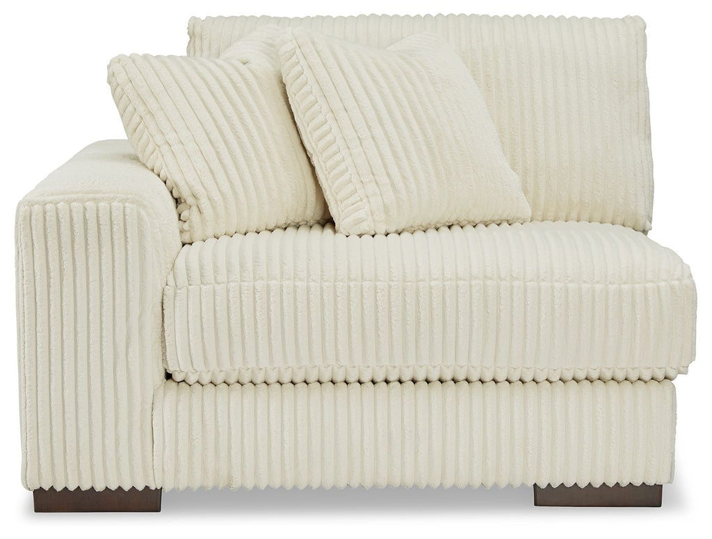 Ivory corner chair with tufted back pillows and padded armrests