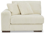 Ivory corner chair with tufted back pillows and padded armrests