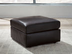 Black rectangular ottoman with cushioned seat and short legs