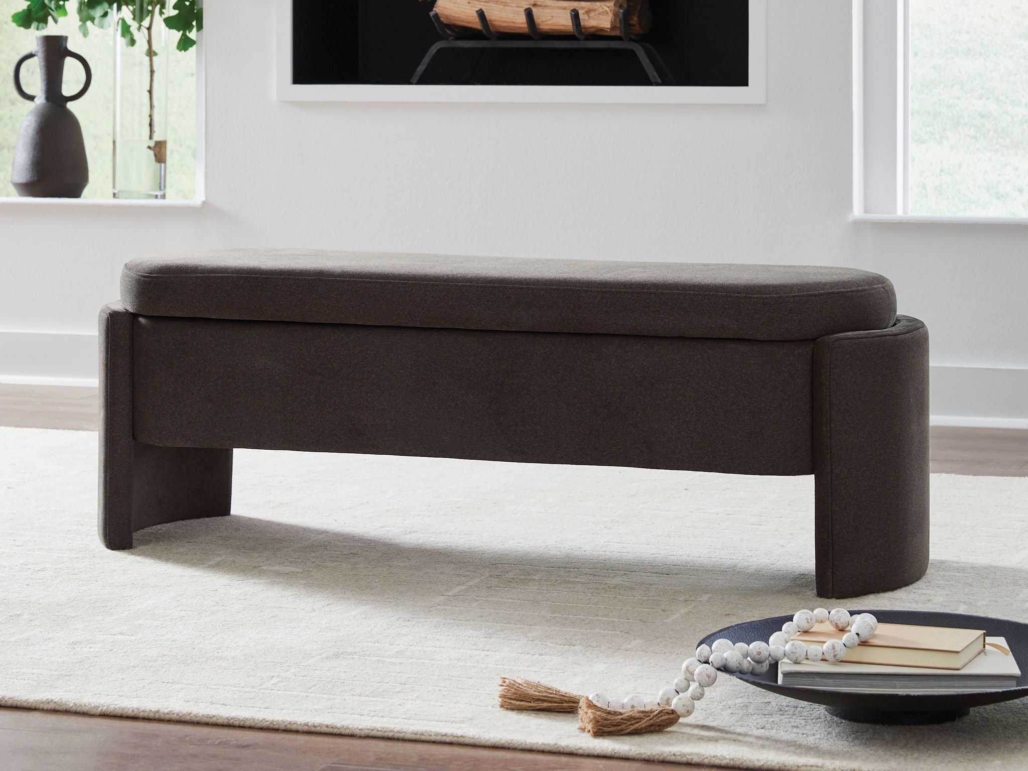 Brown upholstered storage bench with padded top and thick end panels