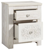 Whitewashed two-drawer night stand with top drawer pulled open to reveal storage