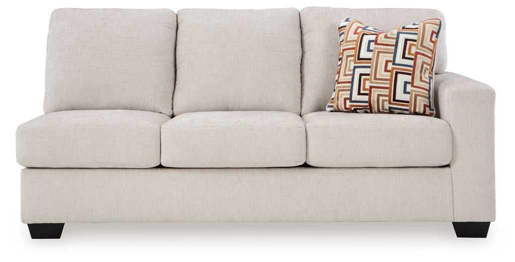 Light beige fabric sofa with three seat cushions, three back cushions, and geometric throw